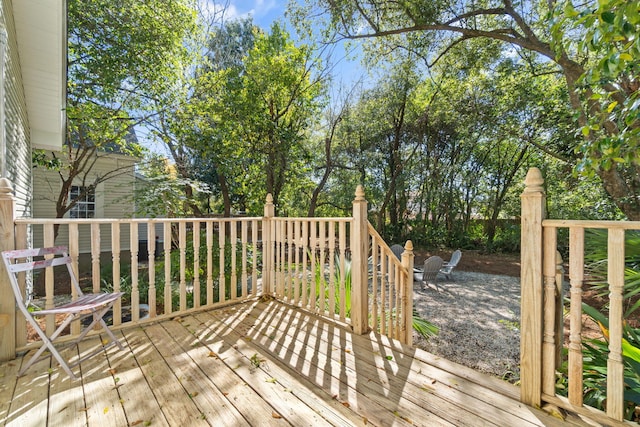 wooden terrace with an outdoor fire pit