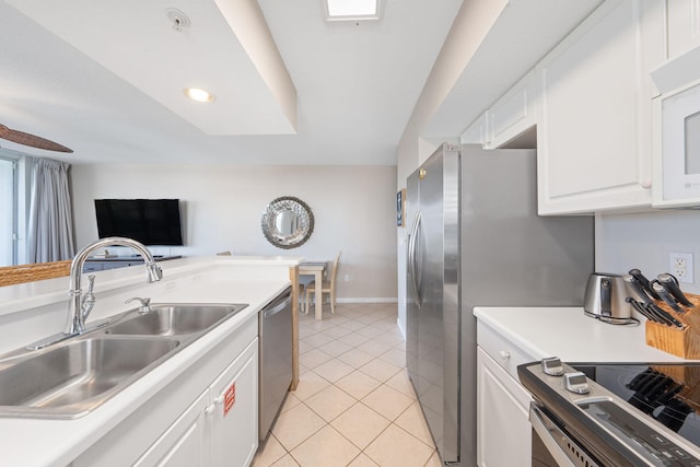 kitchen featuring light countertops, appliances with stainless steel finishes, a sink, and white cabinets