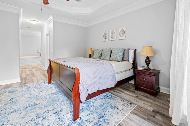 bedroom featuring visible vents, light wood-style floors, ornamental molding, connected bathroom, and baseboards