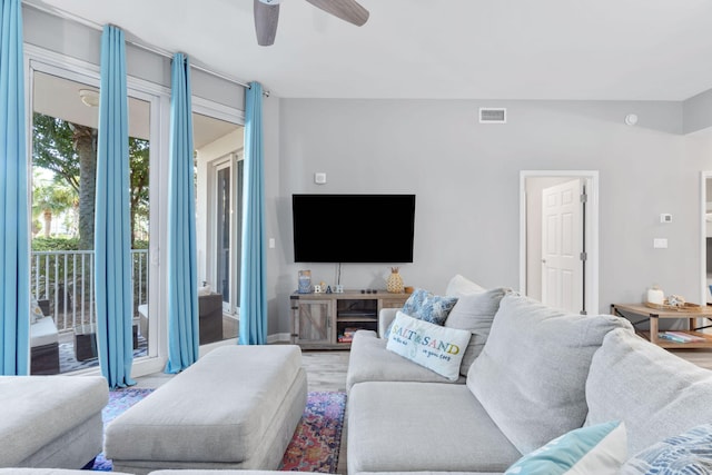 living room featuring ceiling fan, wood finished floors, and visible vents