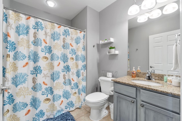 bathroom featuring toilet, a shower with curtain, vanity, and tile patterned floors