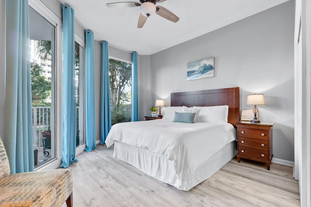 bedroom featuring light wood finished floors, multiple windows, and baseboards