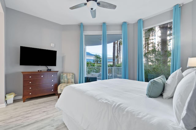 bedroom with access to exterior, ceiling fan, baseboards, and wood finished floors