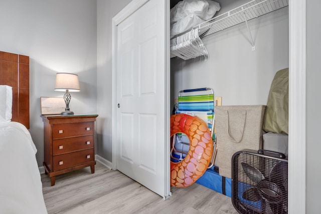 bedroom with wood finished floors and baseboards