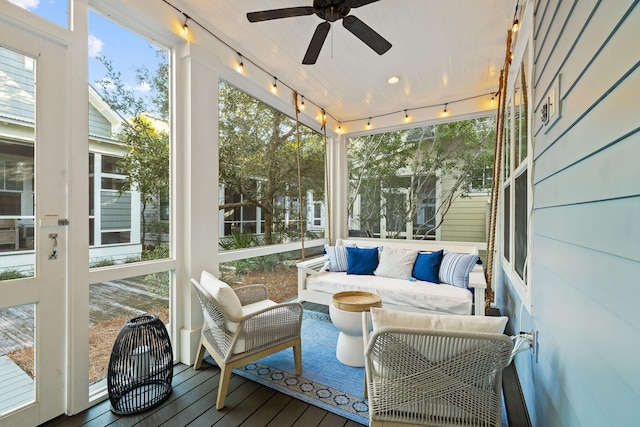 sunroom / solarium with a ceiling fan, a wealth of natural light, and track lighting