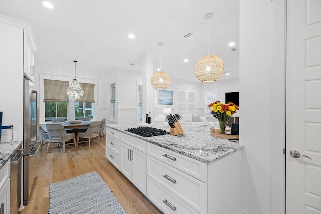 kitchen with white cabinets, light stone counters, black gas cooktop, light wood-style floors, and recessed lighting