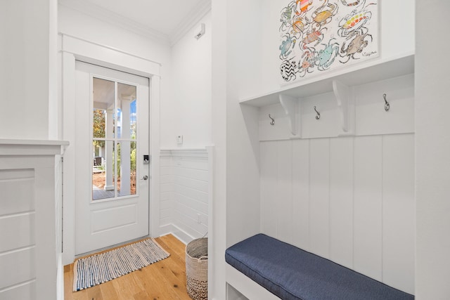 mudroom featuring ornamental molding, wainscoting, and wood finished floors