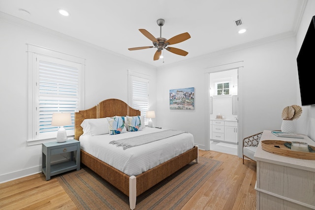 bedroom with light wood-type flooring, crown molding, and baseboards