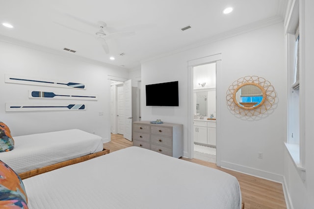 bedroom featuring crown molding, baseboards, visible vents, and light wood-style floors