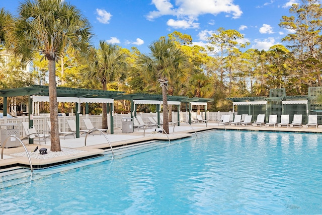 community pool featuring a patio area, fence, and a pergola