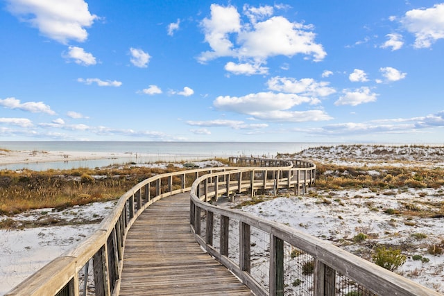 view of home's community featuring a beach view and a water view