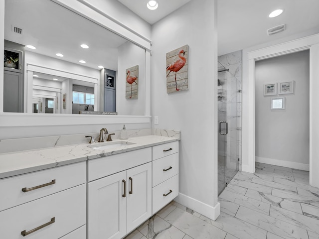 bathroom with marble finish floor, recessed lighting, a stall shower, vanity, and baseboards