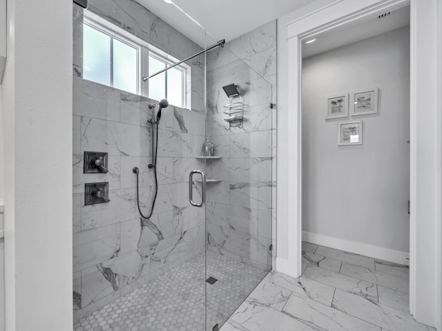 full bathroom with marble finish floor, baseboards, and a marble finish shower