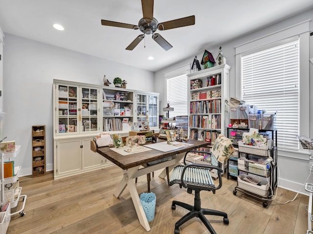 office space featuring baseboards, a ceiling fan, light wood-style flooring, and recessed lighting