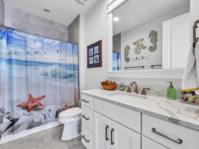 full bathroom with tile patterned flooring, a shower with curtain, vanity, and toilet