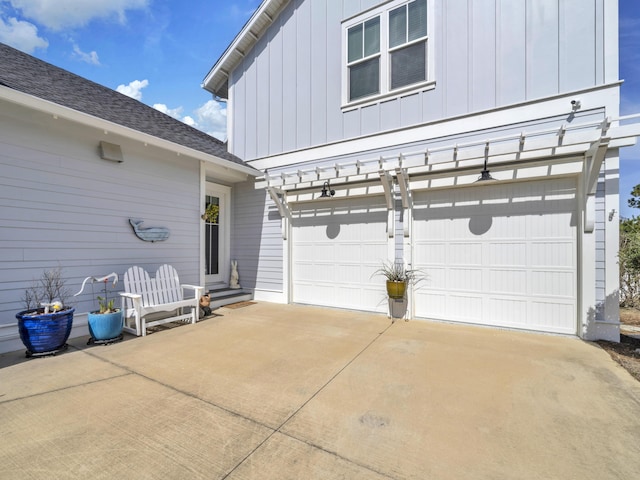 garage featuring concrete driveway