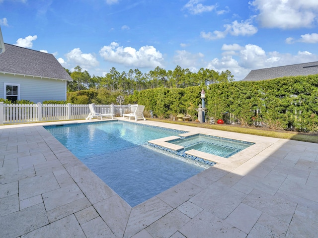 view of swimming pool featuring a patio area, a pool with connected hot tub, and fence