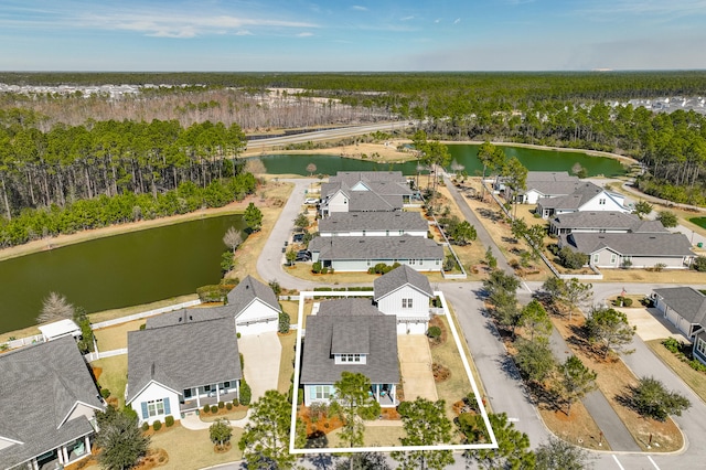 aerial view featuring a residential view, a water view, and a forest view