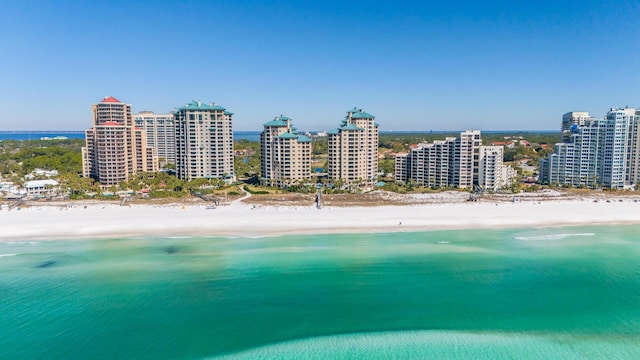 drone / aerial view featuring a view of the beach, a view of city, and a water view