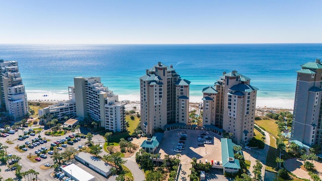 birds eye view of property featuring a water view, a view of the beach, and a city view