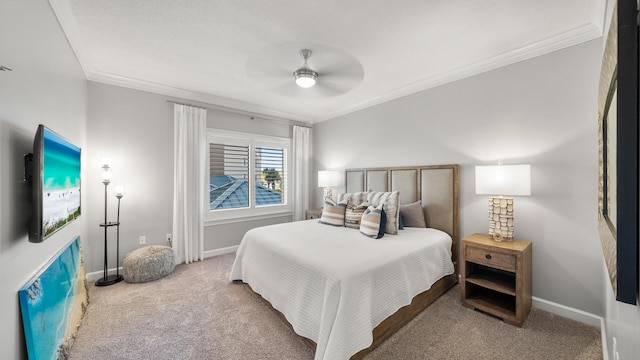 carpeted bedroom with ornamental molding, ceiling fan, and baseboards