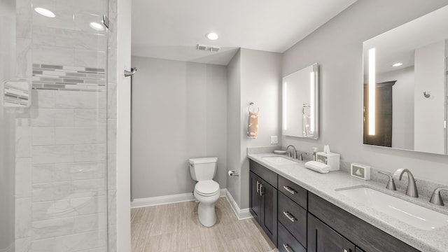 full bathroom with double vanity, a sink, visible vents, and baseboards