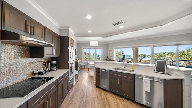 kitchen with a sink, visible vents, stainless steel appliances, and light countertops