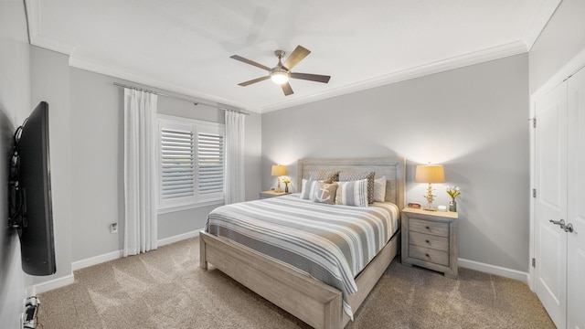 carpeted bedroom with crown molding, ceiling fan, and baseboards