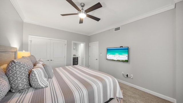 carpeted bedroom featuring crown molding, a closet, visible vents, ceiling fan, and baseboards