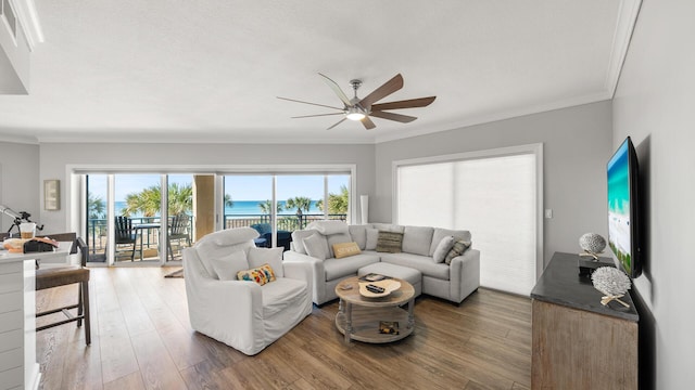 living room featuring crown molding, ceiling fan, and wood finished floors