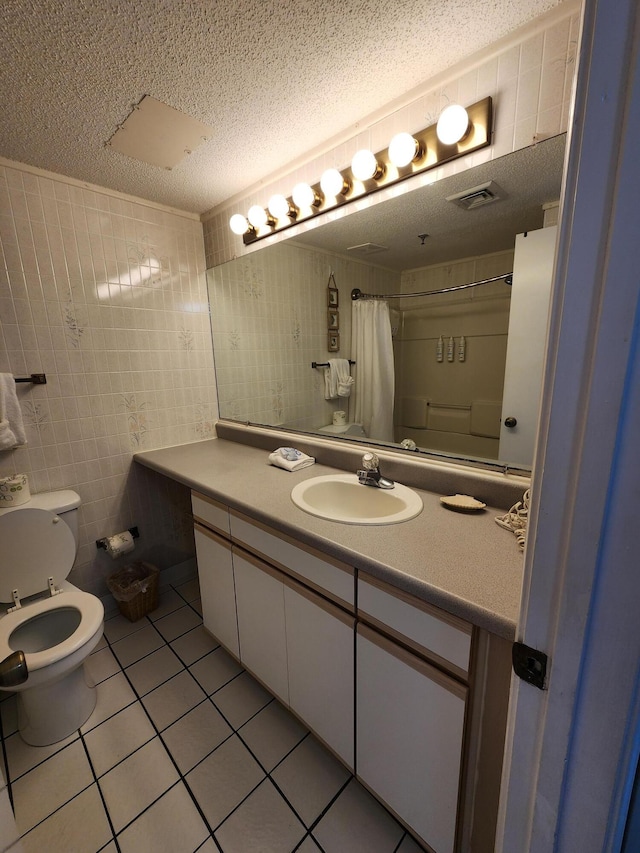 bathroom with tile patterned flooring, visible vents, a textured ceiling, and toilet