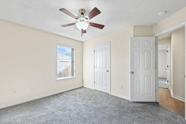 unfurnished bedroom with a ceiling fan, a textured ceiling, baseboards, and carpet flooring