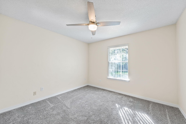 unfurnished room with carpet floors, a textured ceiling, baseboards, and a ceiling fan