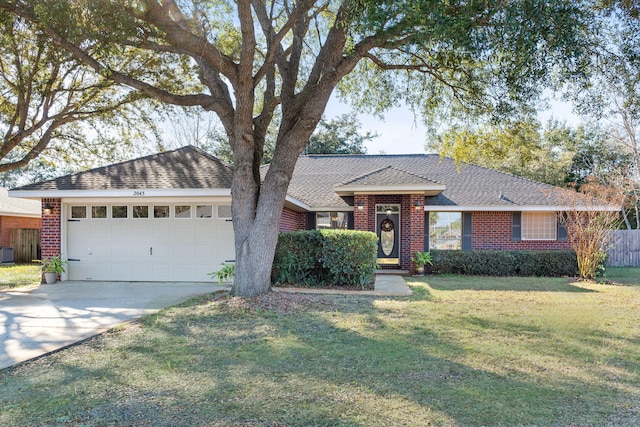 ranch-style house featuring a garage, driveway, a front yard, and brick siding