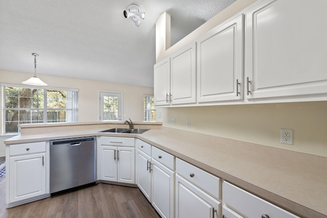 kitchen featuring a sink, white cabinetry, light countertops, dishwasher, and dark wood finished floors