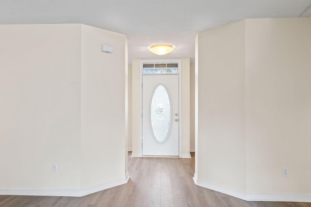 entrance foyer featuring wood finished floors and baseboards