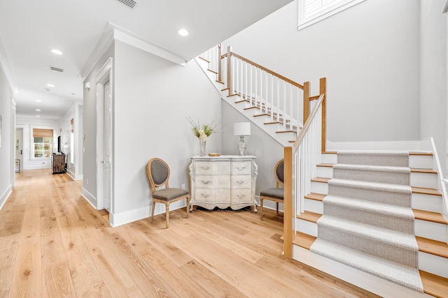 stairway featuring wood-type flooring, baseboards, and recessed lighting