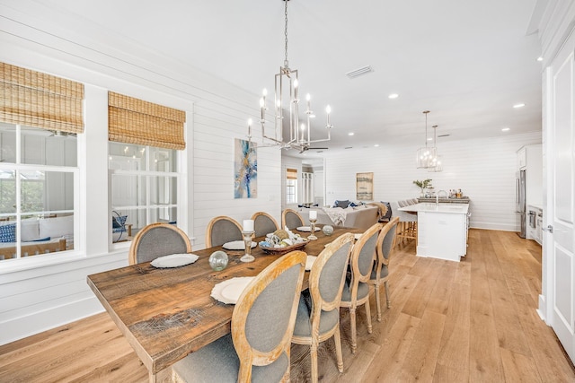 dining space with recessed lighting, visible vents, a notable chandelier, and light wood finished floors