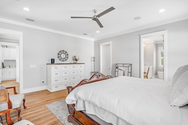 bedroom with light wood-style floors, crown molding, baseboards, and ensuite bathroom