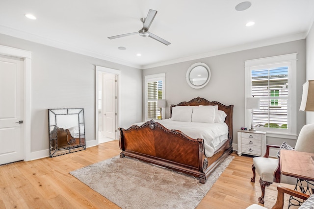 bedroom featuring ornamental molding, multiple windows, light wood-type flooring, and baseboards