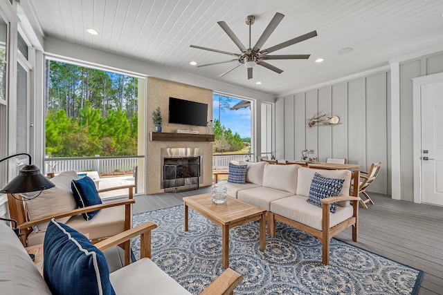 living area featuring recessed lighting, a decorative wall, a fireplace, wood ceiling, and wood-type flooring