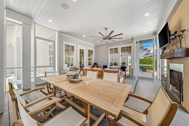 sunroom / solarium with wooden ceiling, a fireplace, french doors, and ceiling fan