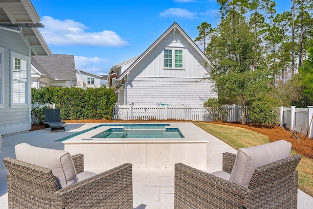 view of pool featuring a jacuzzi, fence, a fenced in pool, and a patio