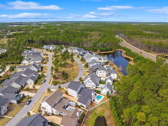 birds eye view of property featuring a residential view, a water view, and a view of trees