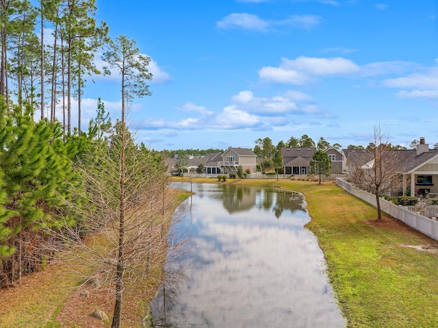 water view with a residential view and fence