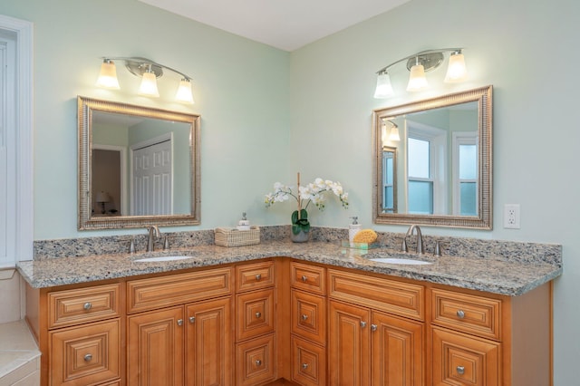 full bath featuring double vanity and a sink