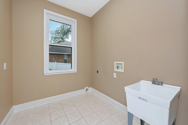 washroom featuring hookup for a washing machine, a sink, electric dryer hookup, laundry area, and baseboards