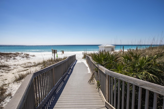 view of community with a water view and a view of the beach