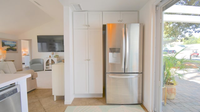 kitchen with light tile patterned floors, stainless steel appliances, light countertops, visible vents, and white cabinets