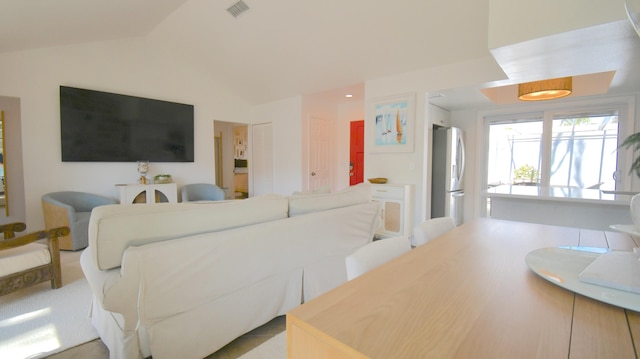 living area with lofted ceiling and visible vents